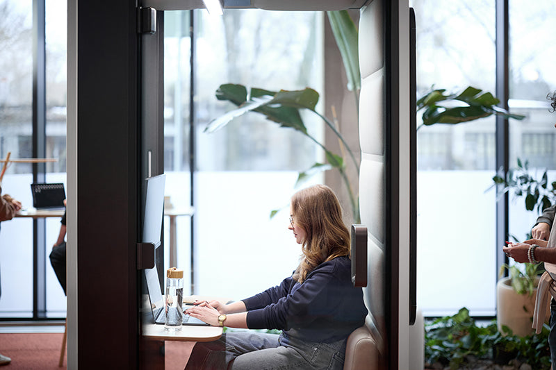Hushoffice acoustic pod used as a mobile workspace in an office