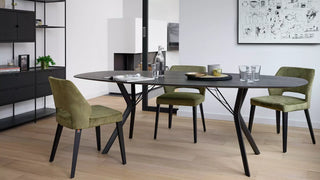 Lifestyle image of olive green Mobitec Lena chairs at a round black table