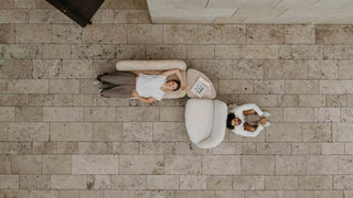 Lifestyle image of a Mobitec Thalia loveseat and armchair on a stone floor, top view