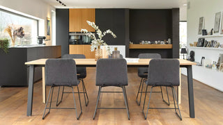 Lifestyle image of grey Mobitec Pamp chairs at a wooden dining table in an open kitchen