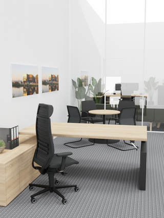Lifestyle image of the black Rovo R12 6070 S5 at a wooden desk in a bright executive office