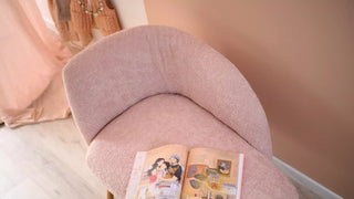 Detail of a pink Mobitec Thalia armchair with magazine