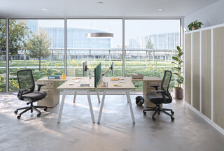Lifestyle image of Buronomic Comfort desk-height pedestals in white and wire oak by a glass facade