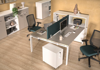 Lifestyle image of a white Buronomic Optimax EVO tower with top box by a twin desk with green screen