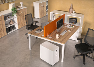 Lifestyle image of a white Buronomic Optimax EVO tower with top box by a twin desk with orange screen