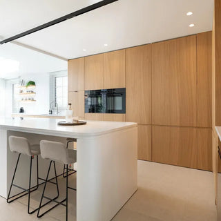 Lifestyle image of Mobitec Pamp bar stools at a white kitchen island with wooden cabinets