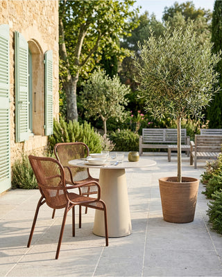 Vincent Sheppard Loop lounge chair in rust from the same Loop collection, lifestyle image